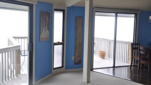 A room with a blue wall, a wooden floor, a large window, and a door leading to a balcony. - Close proximity to Hawksnest, Otter Falls -- and all the High Country offers! (Seven Devils)