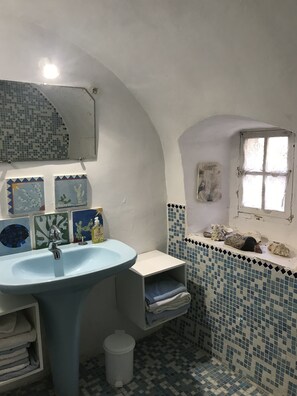 A bathroom with a blue sink, a mirror, and a window. - Into the wild: Charming house, surrounded by nature, large private pool. (Romeyer)