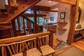 A wooden staircase leading to a dining area with a view of the outdoors. - Pinnacle Ridge 37 - Ski in Ski out, Private Hot Tub, Wood Fireplace (Whistler)