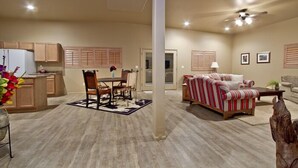 A spacious living area with a dining table, sofas, and a kitchen in the background. - Large Balcony, Exceptional Views. (Tucson)