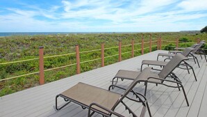A deck with lounge chairs overlooking a beach. - Top Floor Condo. Beautiful Ocean Views. Great Mid-Island Location (Hilton Head Island)