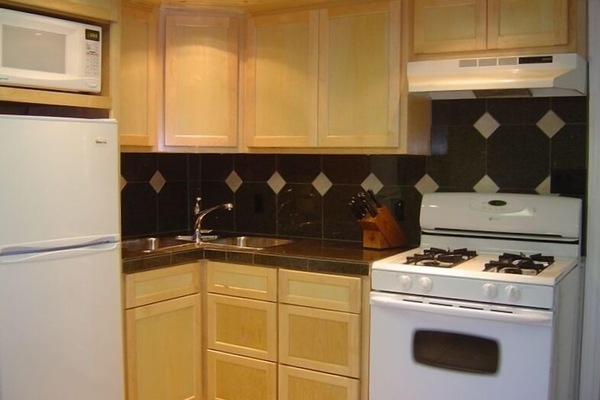 Kitchen with gas range, granite countertops, custom maple cabinets.