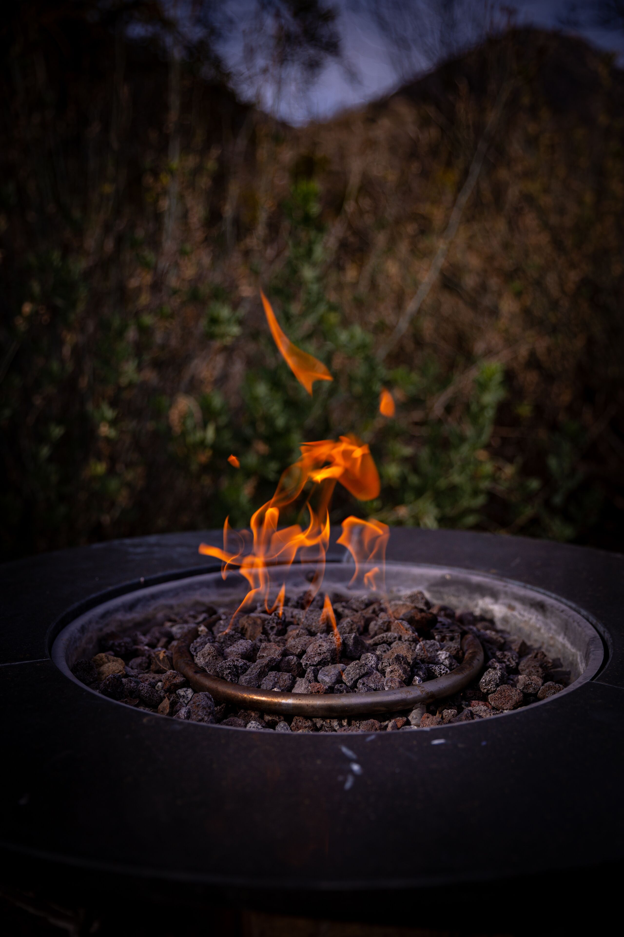 A circular outdoor fire feature with visible flames.