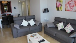 A living room with two grey sofas, a white coffee table, and a black floor lamp. - Apartment  in Alcaidesa (Alcaidesa)