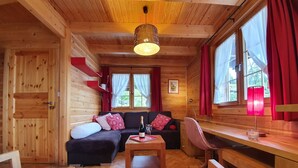 A cozy cabin interior with a wooden interior, a sofa, a dining table, and a desk. - Chalet - La Tzoumaz Verbier - on the slopes (La Tzoumaz)