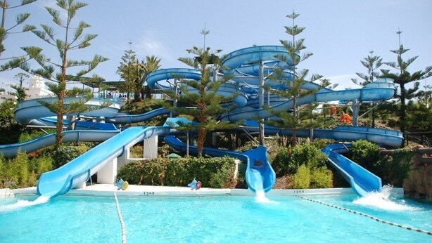 A water park with multiple slides and a pool.