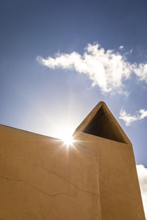 A concrete structure with a clear sky and sunlight.