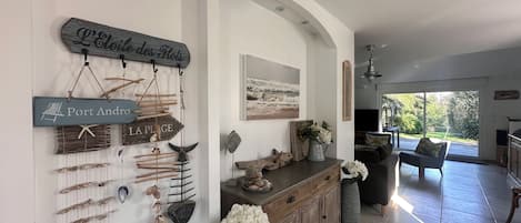 A coastal-themed interior with nautical decor, including wall-mounted signs and shells.