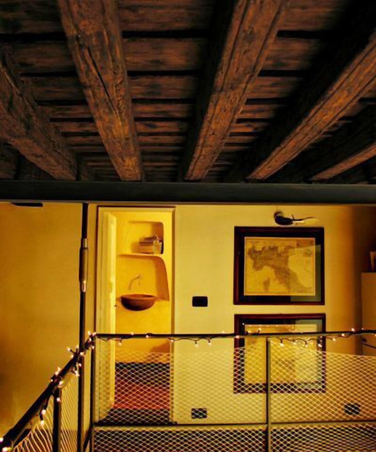 A staircase with a metal railing and a wall with a framed picture.