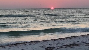 A beach with waves and a sunset. - Sunny 3BR/3BA Home.  8 Houses from Beach.  Two Master Suites. (Holmes Beach)