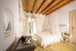 A bedroom with a wooden ceiling, a bed with a canopy, a bedside table, a lamp, and a window with curtains.