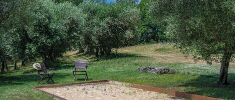 Un campo de croquet al aire libre con dos sillas y un tablero de juego.