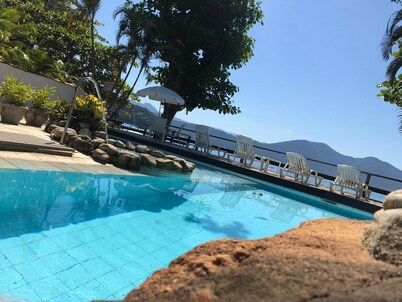Luxury Beach house standing in front sand sea, pool and terrace 