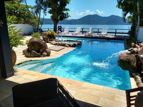 Luxury Beach house standing in front sand sea, pool and terrace 