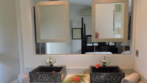 A bathroom with two marble sinks, a large mirror, and a white vanity. - Your own villa with private pool in tropical garden.  (Grand Baie)