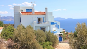 A modern two-story building with a red-tiled roof, blue accents, and a view of the sea. - Villa Stella,  swimming pool, by the beach,  close to Athens
 (Marathon)