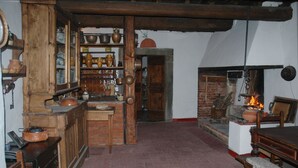 A rustic kitchen with wooden cabinets, a brick wall, and a fireplace. - Ancient country house recently restored - beautiful private garden - panoramic (Pontassieve)