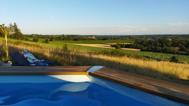 A poolside area with a view of a countryside landscape. - Lots of charm for this house 3 ears, brand new, with its unparalleled panoramic view (Courrensan)