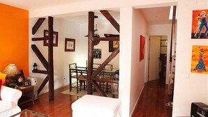 A living room with a wooden staircase, a dining area, and artwork on the walls. - Apartment/ flat - Lisboa (Lisboa)