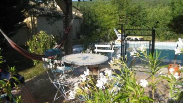 A covered patio area with a pool, outdoor seating, and a hammock. - Stone house of character in a typical Provencal hamlet (Banon)