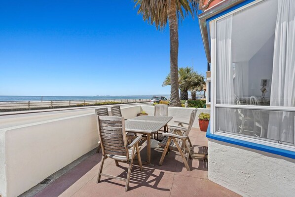 A balcony with a table and chairs, overlooking the sea. - Fabulous Views of the Ocean! (Aptos)