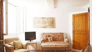 A living room with a sofa, armchair, and a television on a small table. - House / Villa - Collobrières (Collobrières)