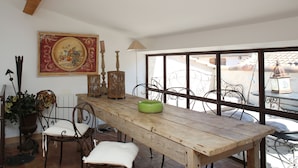 A dining area with a wooden table, metal chairs, a green bowl, a wicker basket, and a decorative painting on the wall. - House / Villa - Collobrières (Collobrières)