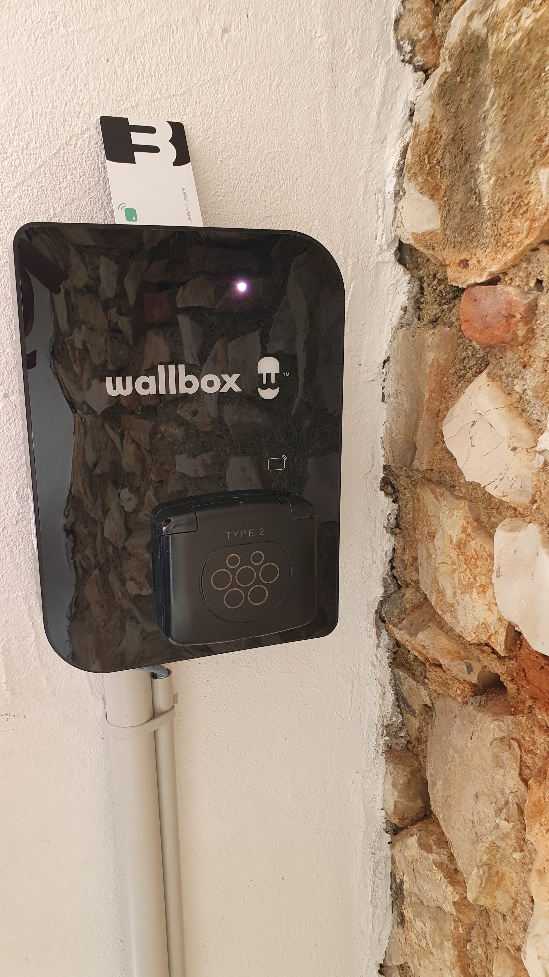 A wallbox with the 'wallbox' logo, a Type 2 plug, and a USB port.