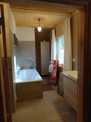 Bathtub, hair dryer, slippers, soap