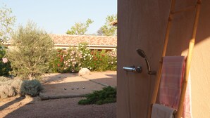 A shower area with a wooden ladder, a towel hanging on the wall, and a garden view. - 4* architect's villa, contemporary, air-conditioned with heated swimming pool (Zonza)