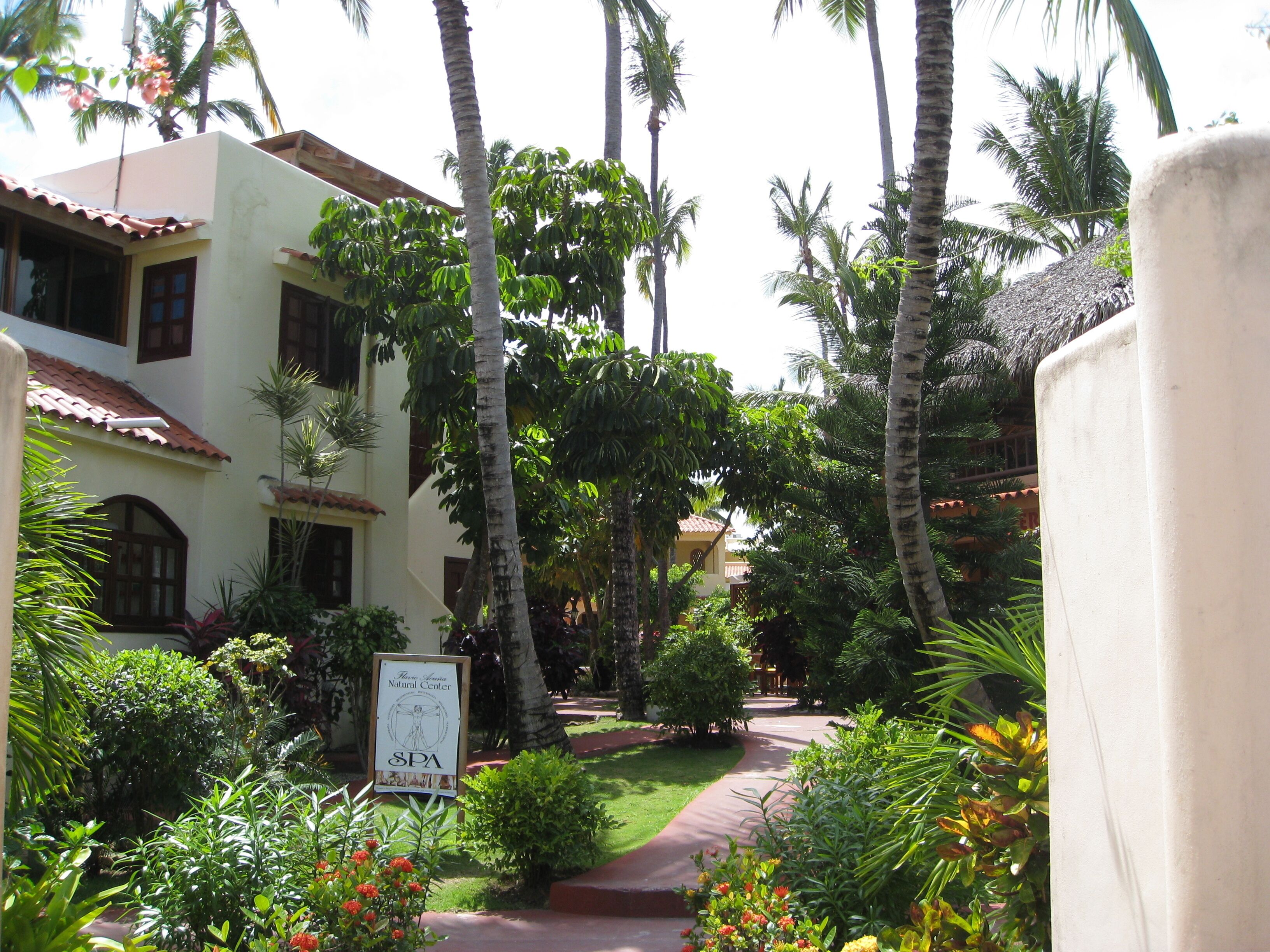 A pathway leading to a building with a sign indicating a spa.