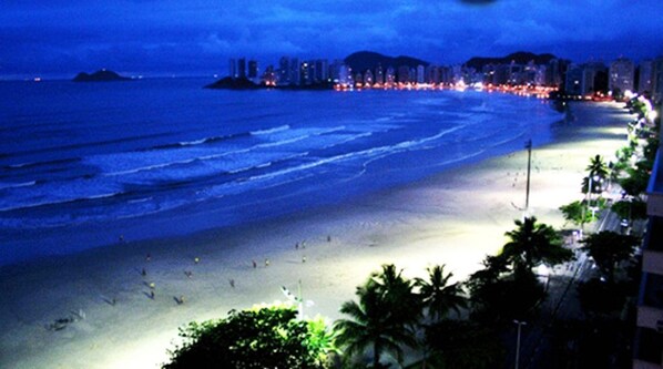 A beach scene with a city skyline in the background.