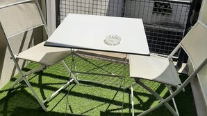 A small outdoor balcony with a table and two chairs, surrounded by a metal railing. - Pleasant T2 excellent location near the old port secure parking, Wifi (La Rochelle)