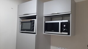 A kitchen with a built-in microwave and oven, a black countertop, and a power outlet. - Pleasant T2 excellent location near the old port secure parking, Wifi (La Rochelle)