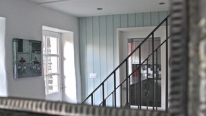 Una escalera con barandilla metálica que conduce a una puerta.