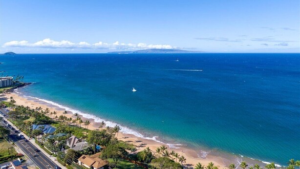 A coastal view with a beach, ocean, and distant mountains. - Quiet, comfortable and across from gorgeous Charley Young beach  (Kihei)
