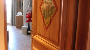 A wooden door with a number "11b" and a diamond-shaped painting.