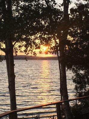 A sunset over a body of water with trees framing the view. - Cozy Cottage on Long Lake in Beautiful Northern Aroostook County, Maine (St. David)