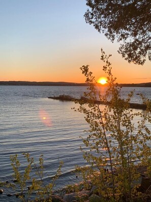 A sunset over a calm lake with trees in the foreground. - Cozy Cottage on Long Lake in Beautiful Northern Aroostook County, Maine (St. David)