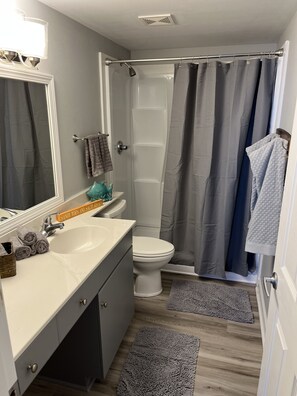 Combined shower/bathtub, towels, toilet paper