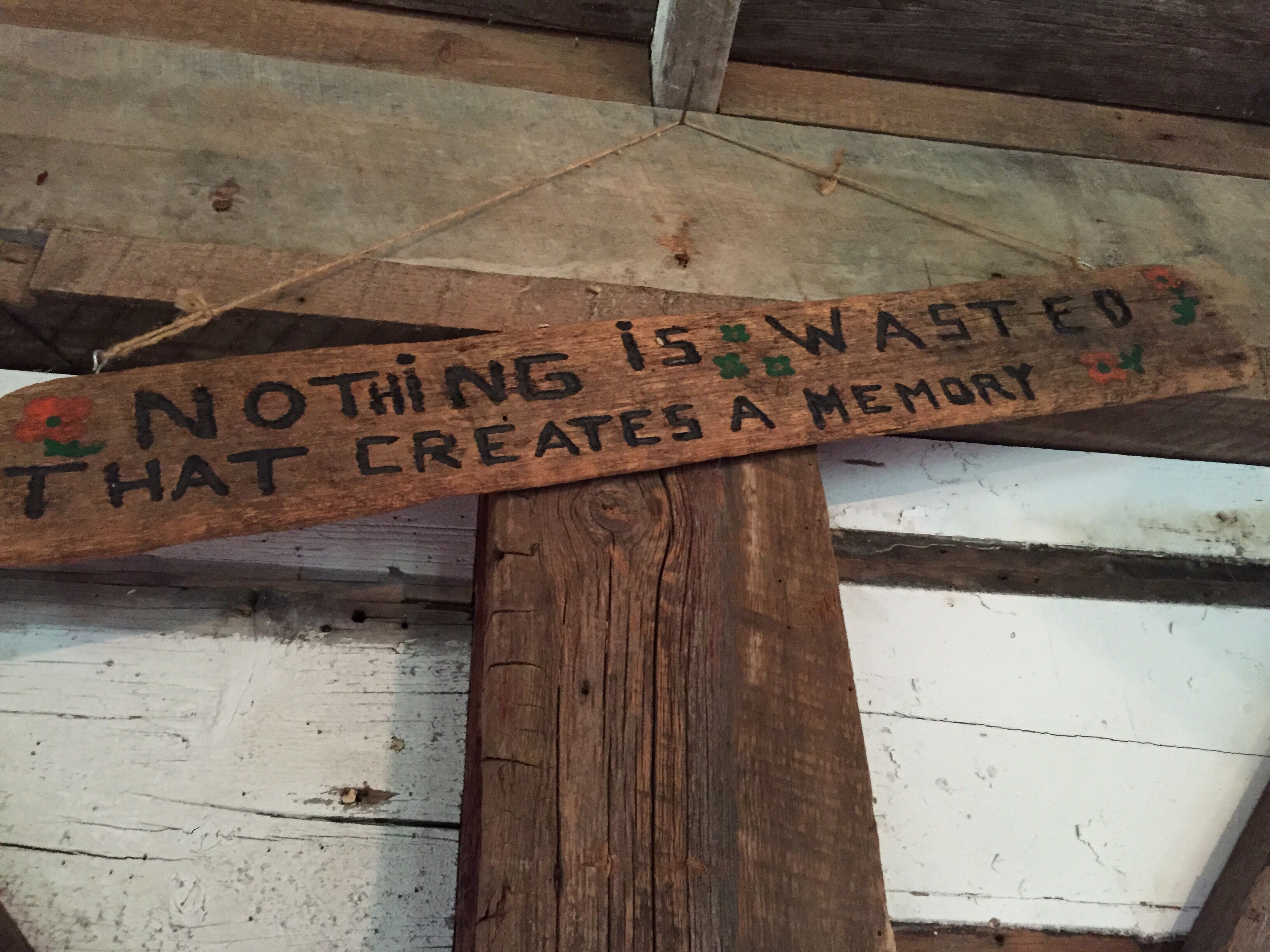 A wooden sign with the text "Nothing is wasted that creates a memory."