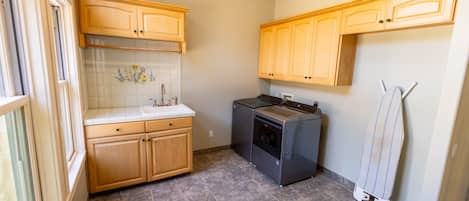 A kitchen with wooden cabinets, a built-in oven, and a tiled backsplash.