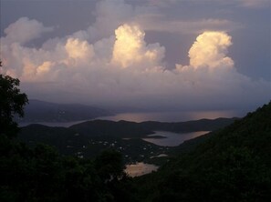 A mountainous landscape with a lake and scattered buildings.