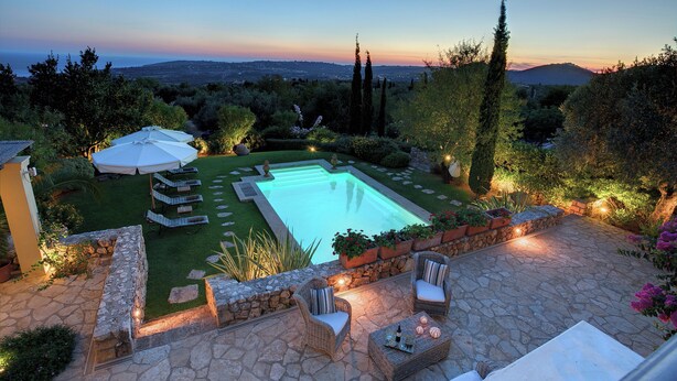 A swimming pool with surrounding stone patio furniture, a lawn, and a view of the landscape. - High-end, sea view, 5 bed villa with Chef, maid, large pool + skippered boat (Moussata)