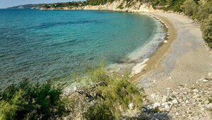 A coastal road with clear turquoise waters, rocky terrain, and dense greenery. - High-end, sea view, 5 bed villa with Chef, maid, large pool + skippered boat (Moussata)
