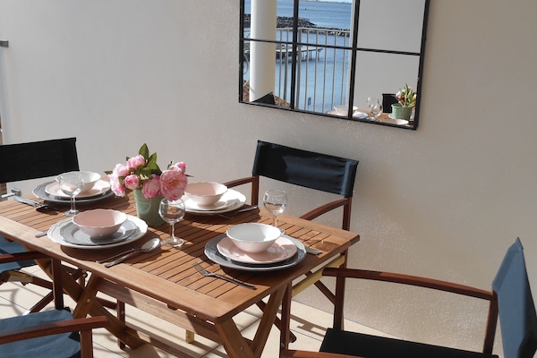 Lunch on the terrace overlooking the port and boats sailing in and out