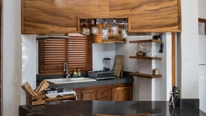 A kitchen with wooden cabinets, a sink, and a countertop.