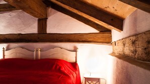 A wooden-framed room with a bed, white walls, and a sloped ceiling. - Apartment/studio (converted barn, 40 sqm) with gallery (Schernfeld)