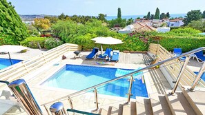 A pool area with multiple pools, sun loungers, and a view of the sea. - Villa With Private Pool Hosting Up To 4 Guests - Great Sea Views. (Coral Bay)