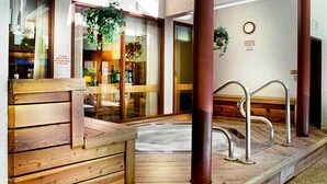 A wooden bench area with a hot tub, metal railings, and potted plants. - Eagle Point Resort Vail Condo available December 18-25, 2026 (Vail)